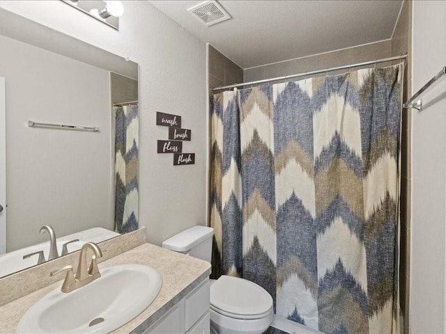 bathroom featuring toilet, visible vents, a shower with shower curtain, and vanity
