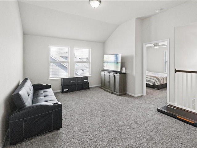 sitting room with a ceiling fan, baseboards, carpet, and vaulted ceiling