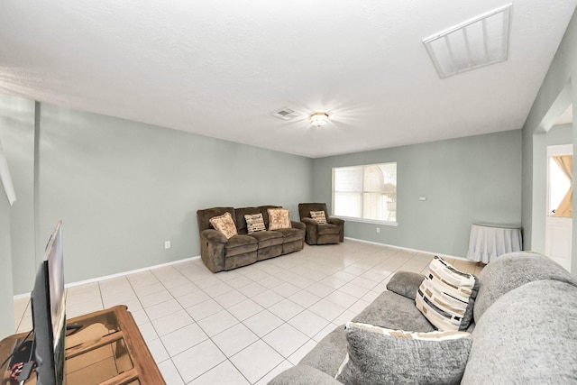 living room featuring light tile patterned flooring, baseboards, and visible vents