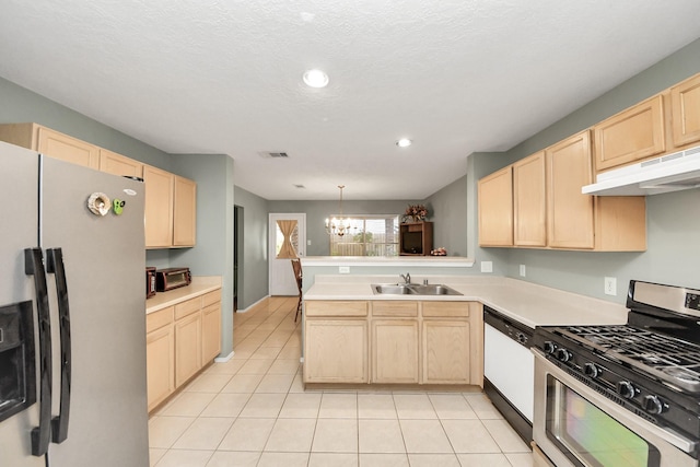 kitchen featuring appliances with stainless steel finishes, a sink, light brown cabinets, a peninsula, and under cabinet range hood