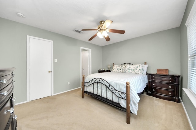 bedroom featuring a ceiling fan, baseboards, light colored carpet, and visible vents