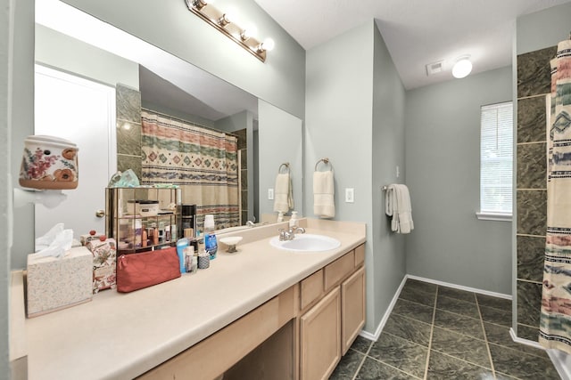 full bath with baseboards, a shower with shower curtain, and vanity