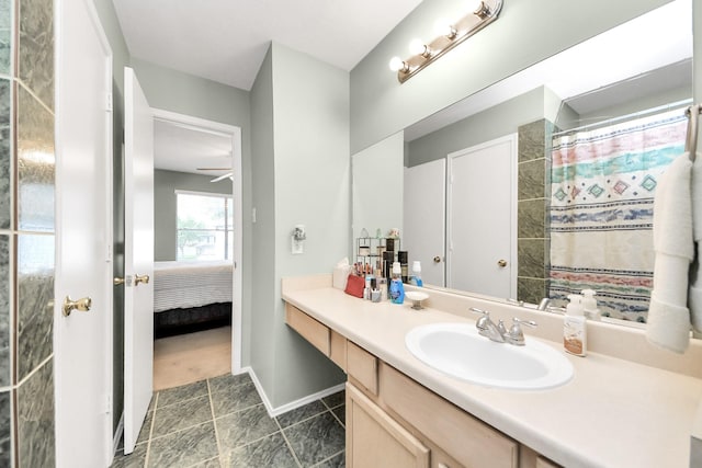 ensuite bathroom with vanity, baseboards, ensuite bathroom, and tile patterned flooring