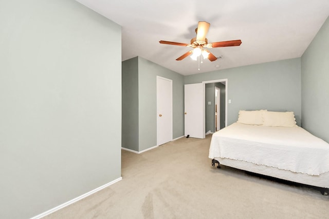 bedroom featuring baseboards, a ceiling fan, and light carpet