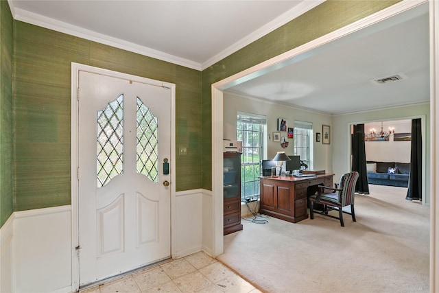 entryway with visible vents, wainscoting, crown molding, and a notable chandelier