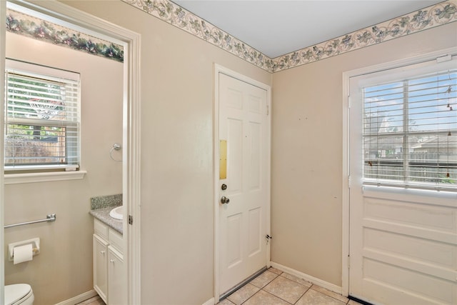 interior space with light tile patterned floors and baseboards