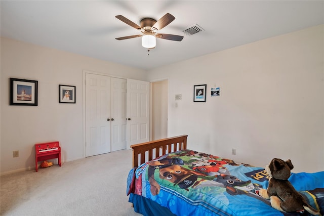 carpeted bedroom with visible vents, a ceiling fan, baseboards, and a closet