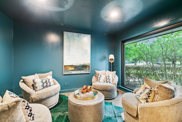 living area featuring baseboards and wood finished floors