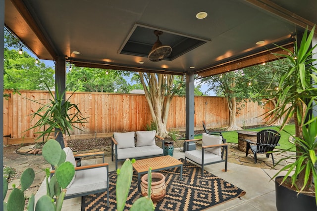 view of patio / terrace with an outdoor living space with a fire pit and a fenced backyard