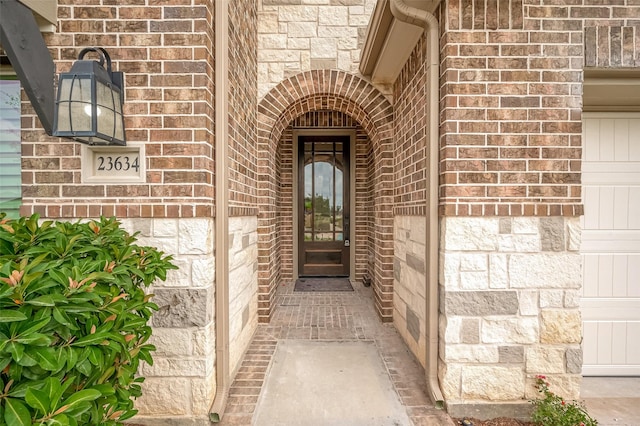 doorway to property featuring brick siding