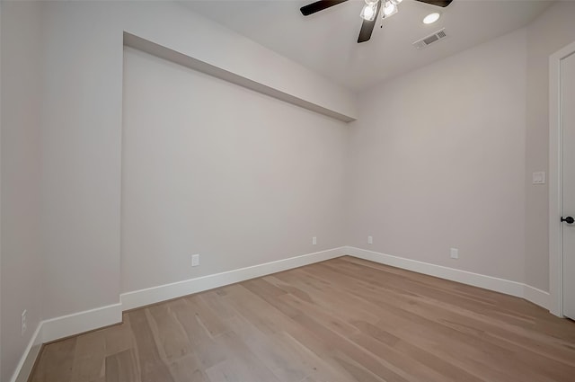 unfurnished room featuring visible vents, baseboards, ceiling fan, and light wood-type flooring