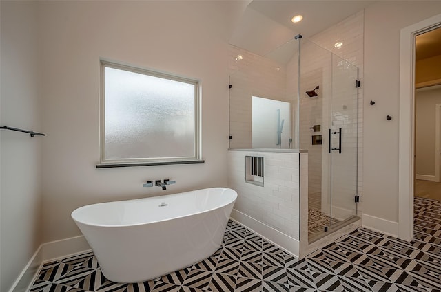bathroom featuring a sink, recessed lighting, a freestanding tub, baseboards, and a stall shower