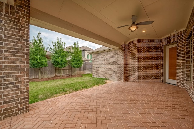 view of patio / terrace with fence and a ceiling fan