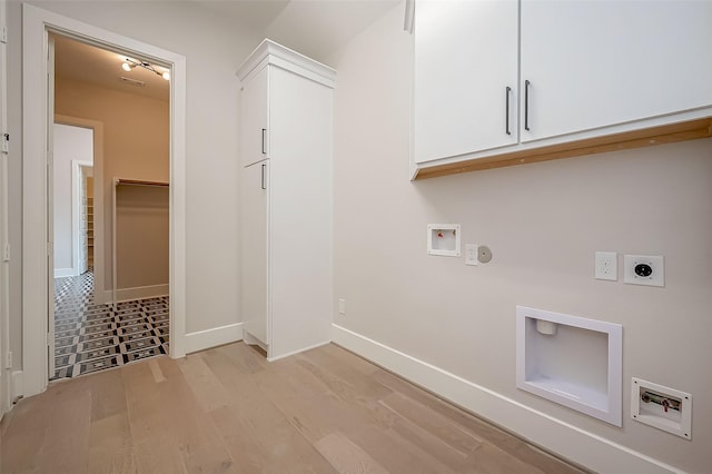 clothes washing area with baseboards, light wood-type flooring, hookup for an electric dryer, cabinet space, and washer hookup