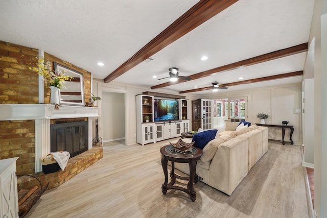 302 Tall Pines Dr, Magnolia, TX 77354 - living area featuring baseboards, light wood finished floors, and beam ceiling
