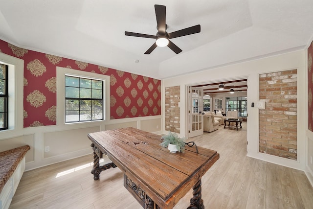 302 Tall Pines Dr, Magnolia, TX 77354 - dining area featuring ceiling fan, wallpapered walls, wainscoting, and light wood finished floors