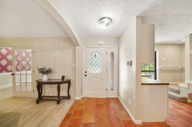 302 Tall Pines Dr, Magnolia, TX 77354 - entrance foyer featuring baseboards, arched walkways, and a textured ceiling