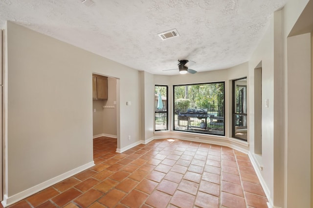 302 Tall Pines Dr, Magnolia, TX 77354 - unfurnished room with light tile patterned floors, ceiling fan, a textured ceiling, and visible vents