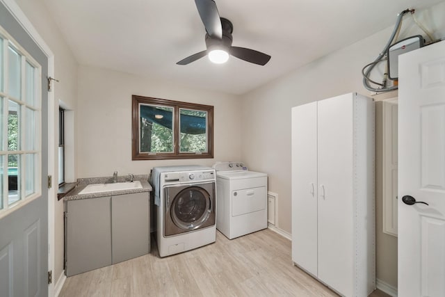 302 Tall Pines Dr, Magnolia, TX 77354 - washroom with light wood-style floors, ceiling fan, washing machine and clothes dryer, a sink, and cabinet space