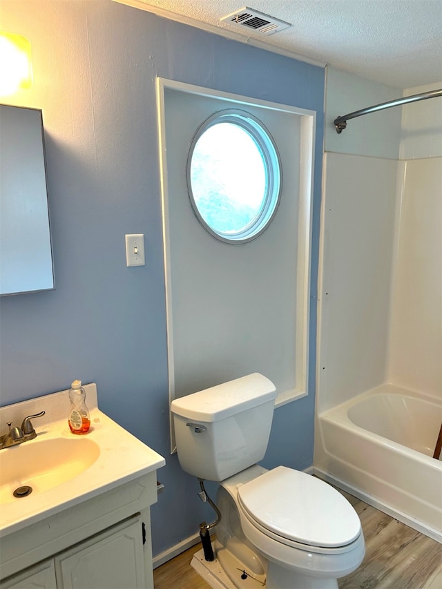 16717 Captain Hook, Jamaica Beach, TX 77554 - full bathroom with visible vents, wood finished floors, toilet, a textured ceiling, and shower / bath combination