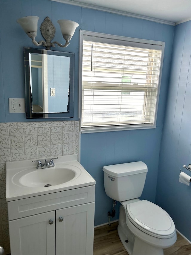 16717 Captain Hook, Jamaica Beach, TX 77554 - bathroom featuring vanity, crown molding, wood finished floors, and toilet