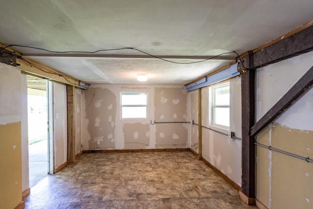 16717 Captain Hook, Jamaica Beach, TX 77554 - below grade area featuring baseboards and a healthy amount of sunlight