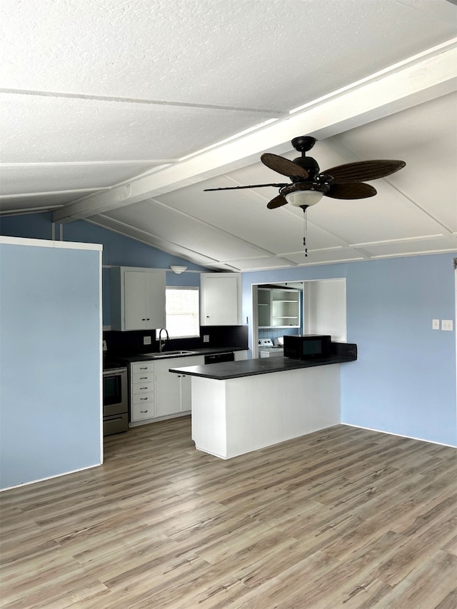 16717 Captain Hook, Jamaica Beach, TX 77554 - kitchen featuring dark countertops, lofted ceiling with beams, light wood-type flooring, white cabinets, and electric stove