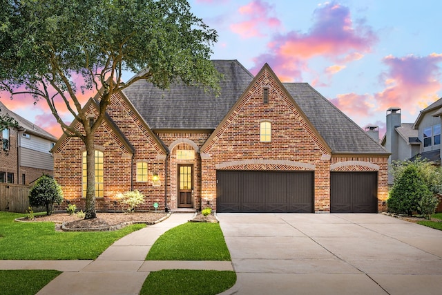 view of front of home with brick siding, a shingled roof, concrete driveway, and an attached garage
