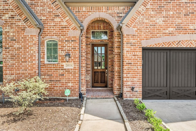 view of exterior entry with brick siding