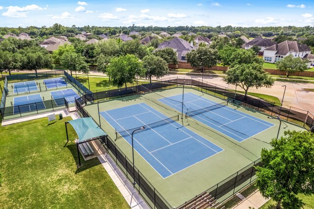 view of tennis court featuring a residential view