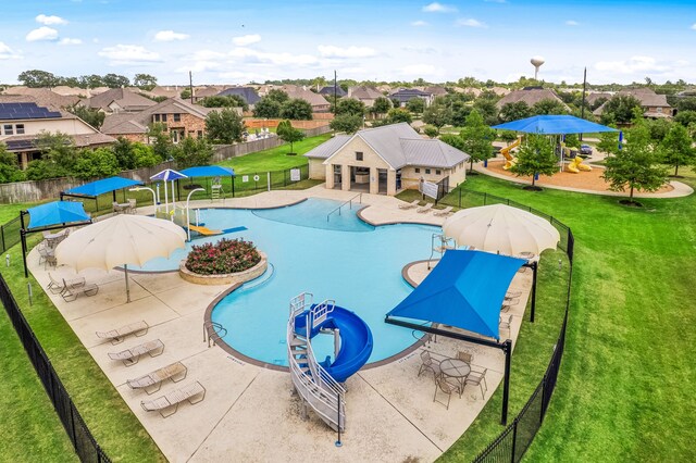 community pool with a residential view and a patio