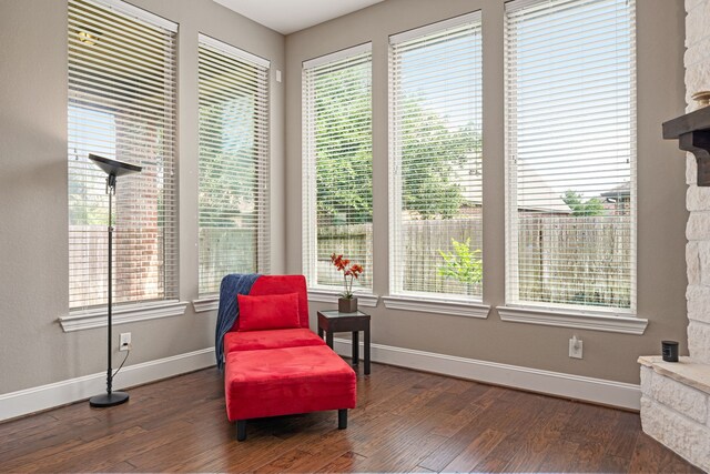 living area featuring baseboards and dark wood-style flooring