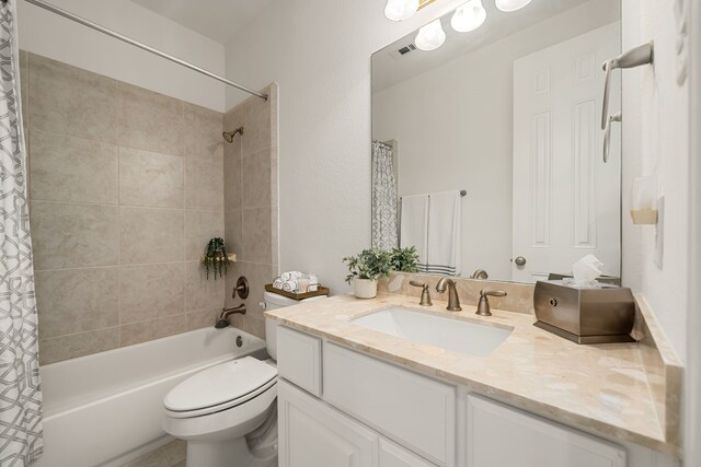 bathroom featuring toilet, shower / tub combo, and vanity