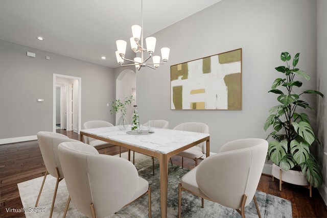dining area with baseboards, recessed lighting, wood finished floors, a chandelier, and arched walkways