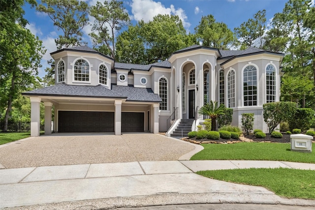11 Twin Greens Ct, Houston, TX 77339 - mediterranean / spanish-style house featuring driveway, stucco siding, roof with shingles, and a front yard