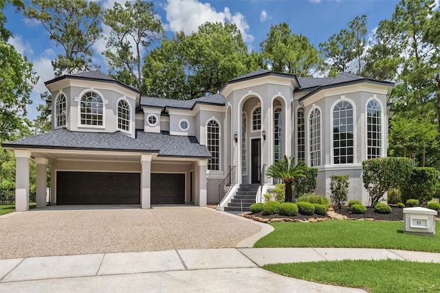 11 Twin Greens Ct, Houston, TX 77339 - view of front of home with driveway, stucco siding, roof with shingles, and a front yard