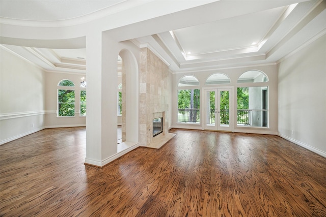11 Twin Greens Ct, Houston, TX 77339 - unfurnished living room featuring a tray ceiling, crown molding, and wood finished floors