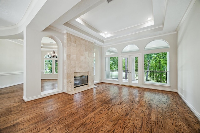 11 Twin Greens Ct, Houston, TX 77339 - unfurnished living room with a tray ceiling, ornamental molding, a notable chandelier, and wood finished floors