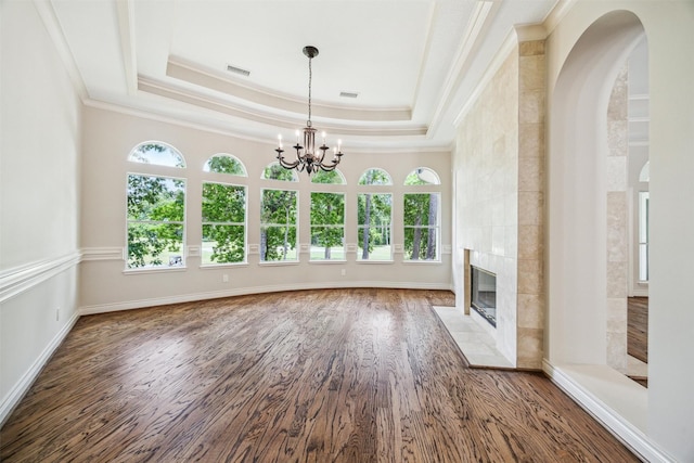 11 Twin Greens Ct, Houston, TX 77339 - unfurnished living room featuring wood finished floors, ornamental molding, visible vents, a chandelier, and a tiled fireplace