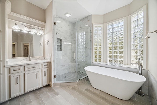11 Twin Greens Ct, Houston, TX 77339 - full bath featuring a marble finish shower, vanity, a freestanding bath, and wood finish floors