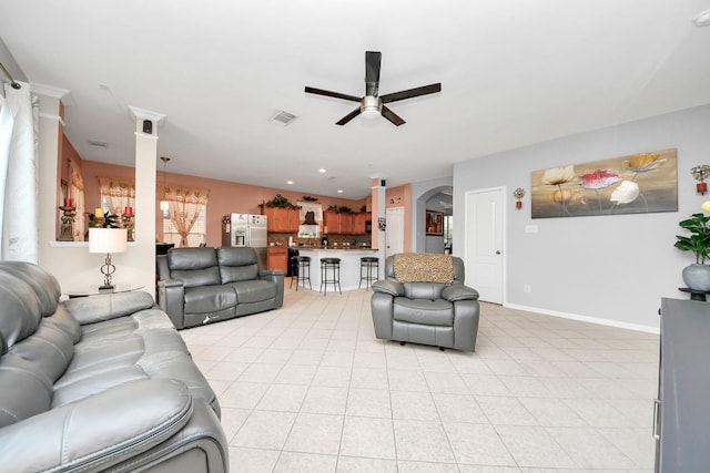 20115 Sunflower Chase Dr, Katy, TX 77449 - living area with a ceiling fan, arched walkways, light tile patterned floors, and baseboards