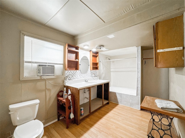 6710 County Road 203, Liverpool, TX 77577 - full bathroom with toilet, cooling unit, tiled shower / bath, vanity, and wood finished floors