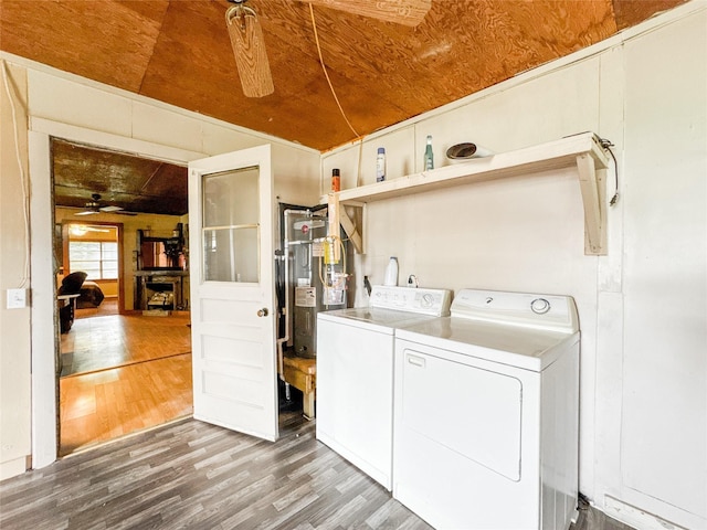 6710 County Road 203, Liverpool, TX 77577 - laundry area with wood finished floors, a ceiling fan, washing machine and clothes dryer, laundry area, and water heater