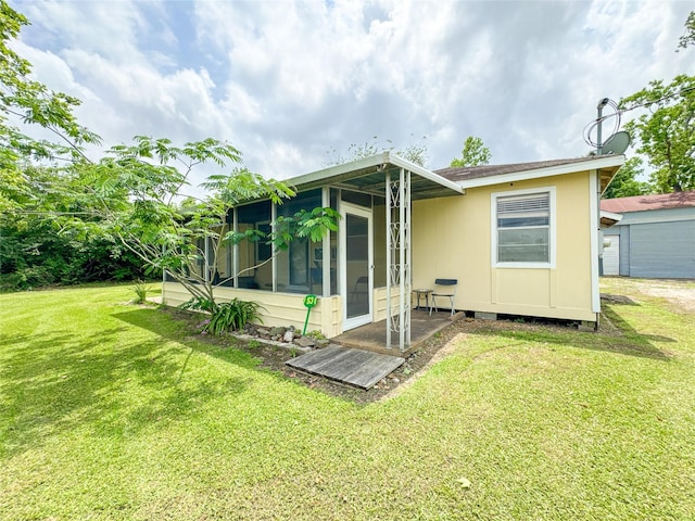 6710 County Road 203, Liverpool, TX 77577 - rear view of property with a sunroom and a lawn
