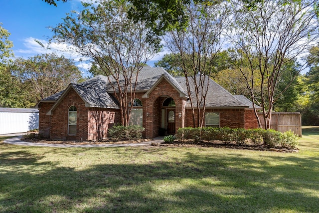 20111 Hilltop Ranch Dr, Montgomery, TX 77316 - view of front of house featuring fence, brick siding, and a front yard