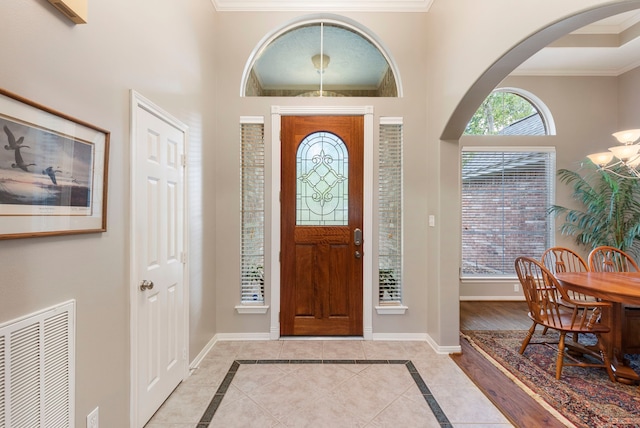 20111 Hilltop Ranch Dr, Montgomery, TX 77316 - foyer entrance with crown molding, arched walkways, and visible vents