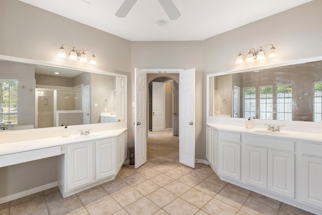 20111 Hilltop Ranch Dr, Montgomery, TX 77316 - bathroom featuring a stall shower, tile patterned flooring, two vanities, and a sink