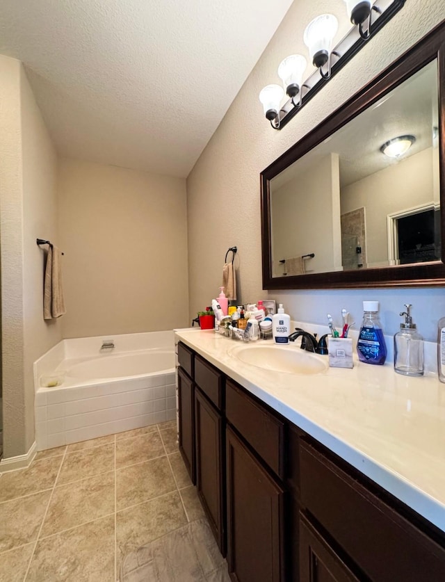 bathroom with a bath, a tile shower, vanity, and a textured ceiling