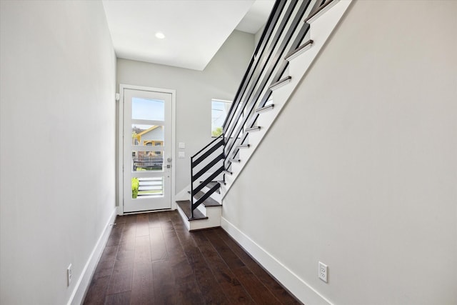 foyer featuring dark wood finished floors, stairway, baseboards, and recessed lighting