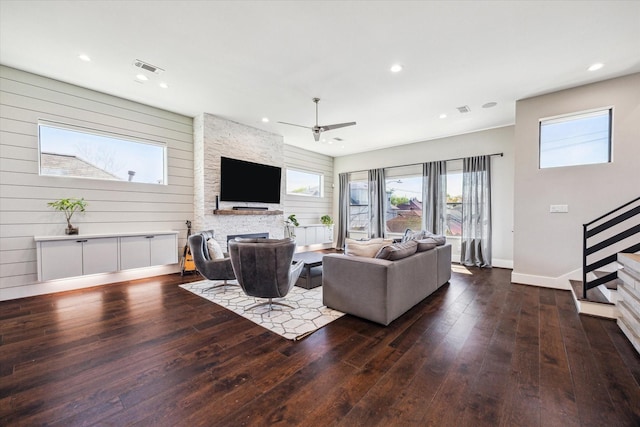 living room featuring hardwood / wood-style flooring, visible vents, stairway, a ceiling fan, and baseboards